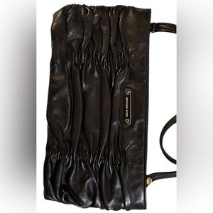 A Michael Kors, black leather Webster wristlet bag